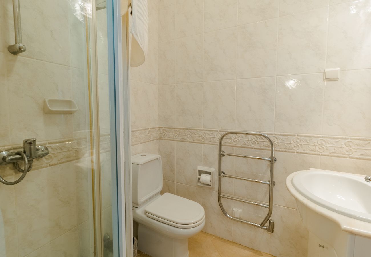 Salle de bain avec douche et sèche-serviettes